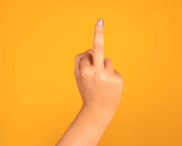 fuck you hand gesture, yellow background