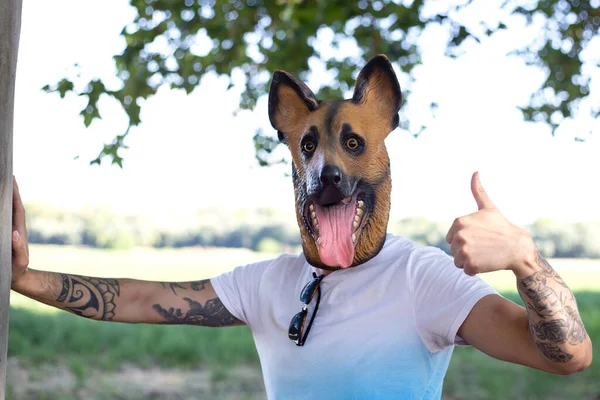 Tattooed man with dog mask on the street funny crazy man