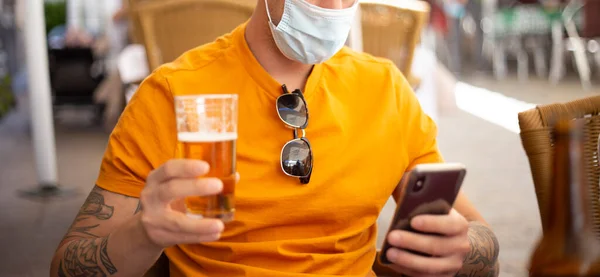 Coronavirus. man with beer, wearing protective mask. Social distancing. Drink security.