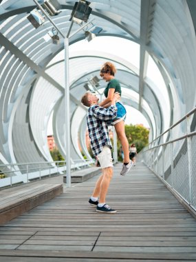 Sevimli mutlu çift eğleniyor ve sarılıyor. Erkeğin kadını kaldırması