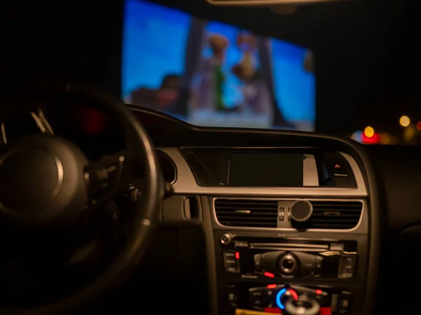 Açık hava sinemasında bir arabanın içi.