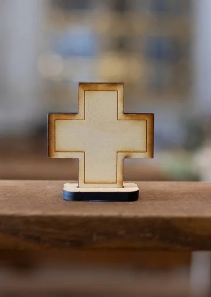 wooden cross on a church blur background