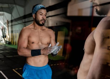 Spor salonundaki adamın elinde magnezyum kullandığı fotoğraf montajı.