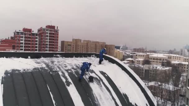 Gli Scalatori Industriali sgomberano un tetto dalla neve accumulata in Mosca. Aerea . — Video Stock