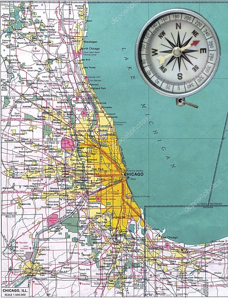 Aged compass on map of Chicago as background