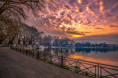 View to the lake Pamvotis at sunset. Ioannina city, Greece.  clipart