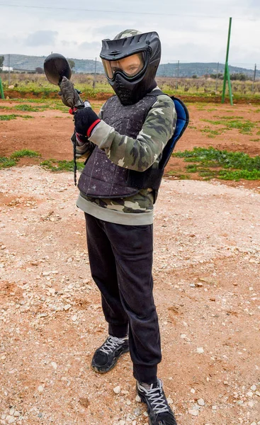 Kid is ready to play a paintball game