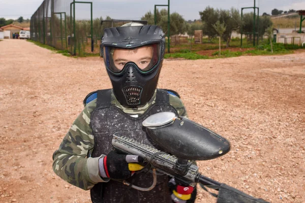 Kid is ready to play a paintball game
