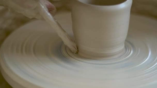 La fabrication de céramiques. L'homme sculpte de l'argile sur la roue de poterie — Video