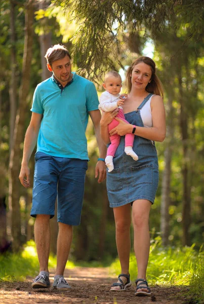 Matka, ojciec i dziecko spacerujący po parku. — Zdjęcie stockowe