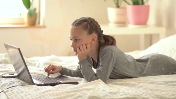 Cute child use laptop for education, online study, home studying. Girl have homework at home schooling. — Stock Video