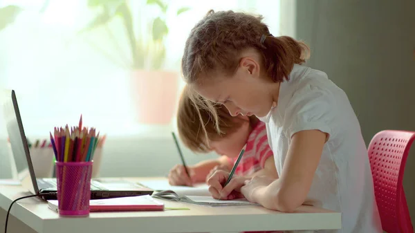 Cute children use laptop for education, online study, home studying. Boy and Girl have homework at distance learning. Concept for home schooling — Stock Photo, Image