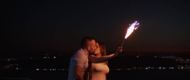 Young Couple Kissing Hugging Smiling While Holding Firework Hill Night — Stock Video