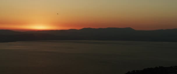 Beau paysage avec coucher de soleil sur le grand lac et les montagnes. Panoramique à gauche. 