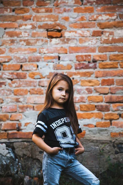 Beautiful little Girl in ragged jeans.fashion child — Stock Photo, Image