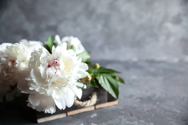 Peonies in wooden box. — Stock Photo, Image