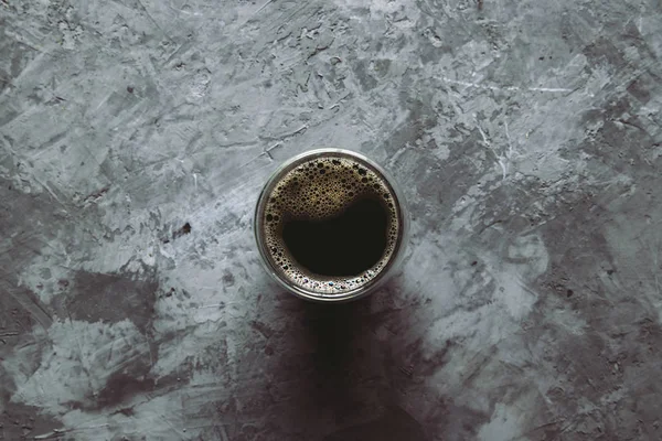 gri arka planda fotoğraflanan aromatik Türk kahvesi ile dolu büyük şeffaf cam