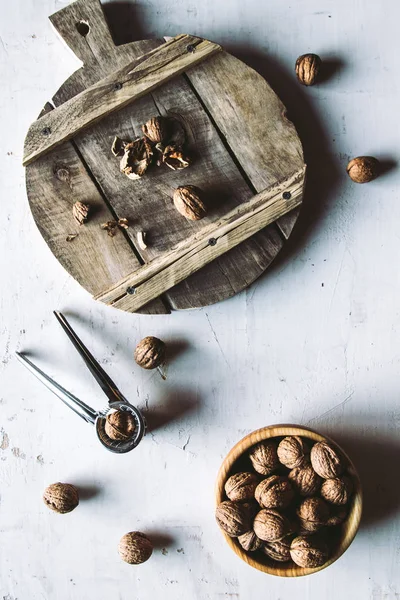 Nueces en cuenco de madera sobre mesa con Cascanueces . — Foto de Stock