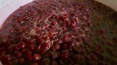 Cooking organic fruit jam in a big pot