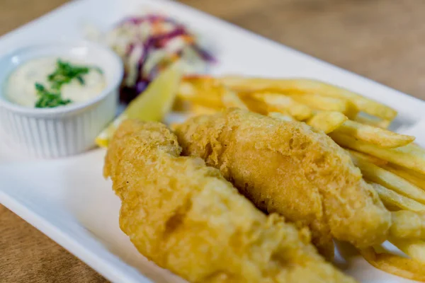 British Traditional fish and chips and tartar sauce and served with coleslaw.
