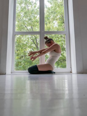 Güzel genç kız pencere ve ayna tarafından stüdyoda dans