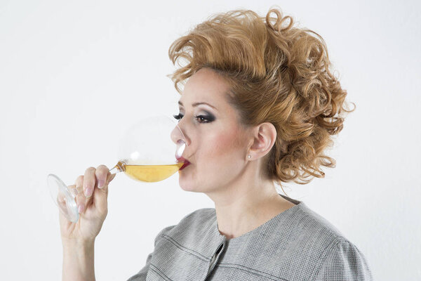 Side View Of Beautiful Woman With Perfect Hairstyle And Makeup Drinking Glass Of White Wine,White Background