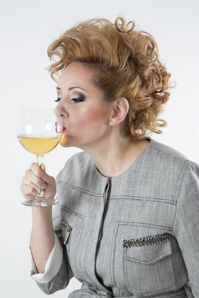 Side View Of Beautiful Woman With Perfect Hairstyle And Makeup Kissing Glass Of White Wine,White Background