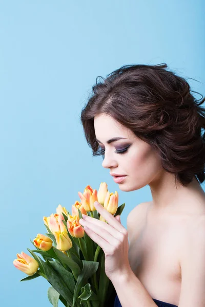 Woman with tulips. Beauty and fashion. Springtime.