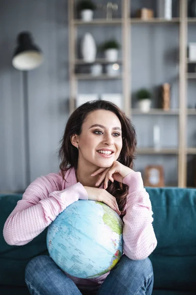 Heureuse femme qui planifie un voyage ou des vacances d'été avec globe du monde rire et sourire . — Photo