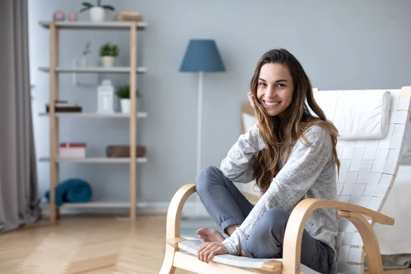 Happy friendly woman posing indoor at home in casual clothes.