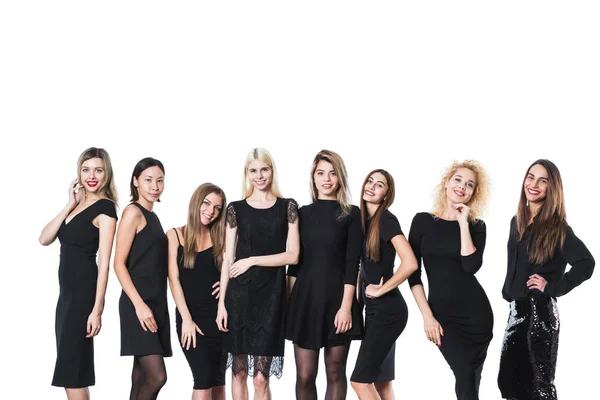 Group of young beautiful women in black dress isolated on white background. — Stock Photo, Image