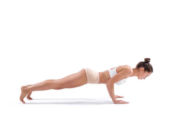 Beautiful sporty woman doing exercise on the floor isolated on white background. — Stock Photo, Image