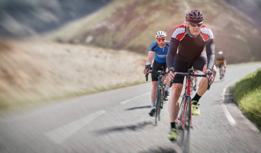 Cyclists out racing along country lanes clipart