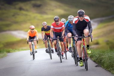 Cyclists out racing along country lanes clipart