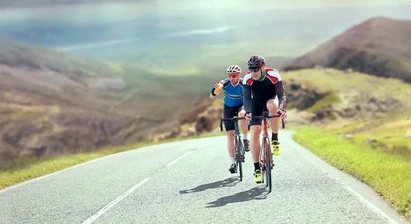 Cyclists out racing along country lanes — Stock Photo, Image