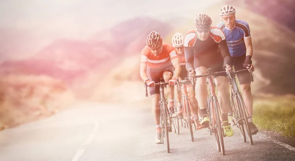 Cyclists out racing along country lanes — Stock Photo, Image