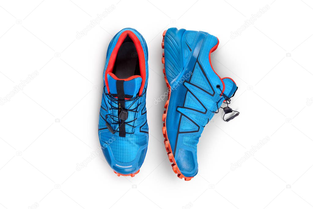 Top view of blue and orange trainers isolated on a white backgro