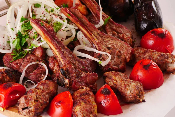 Beyaz arka planda çeşitli kebaplar. Kemikte ızgara et, kıyma.
