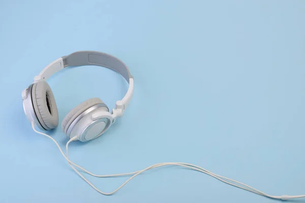 Auriculares sobre fondo pastel azul — Foto de Stock