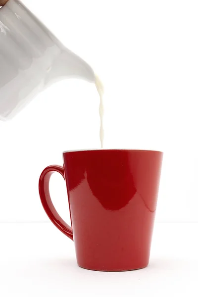 Čerstvé mléko v barevných šálcích — Stock fotografie