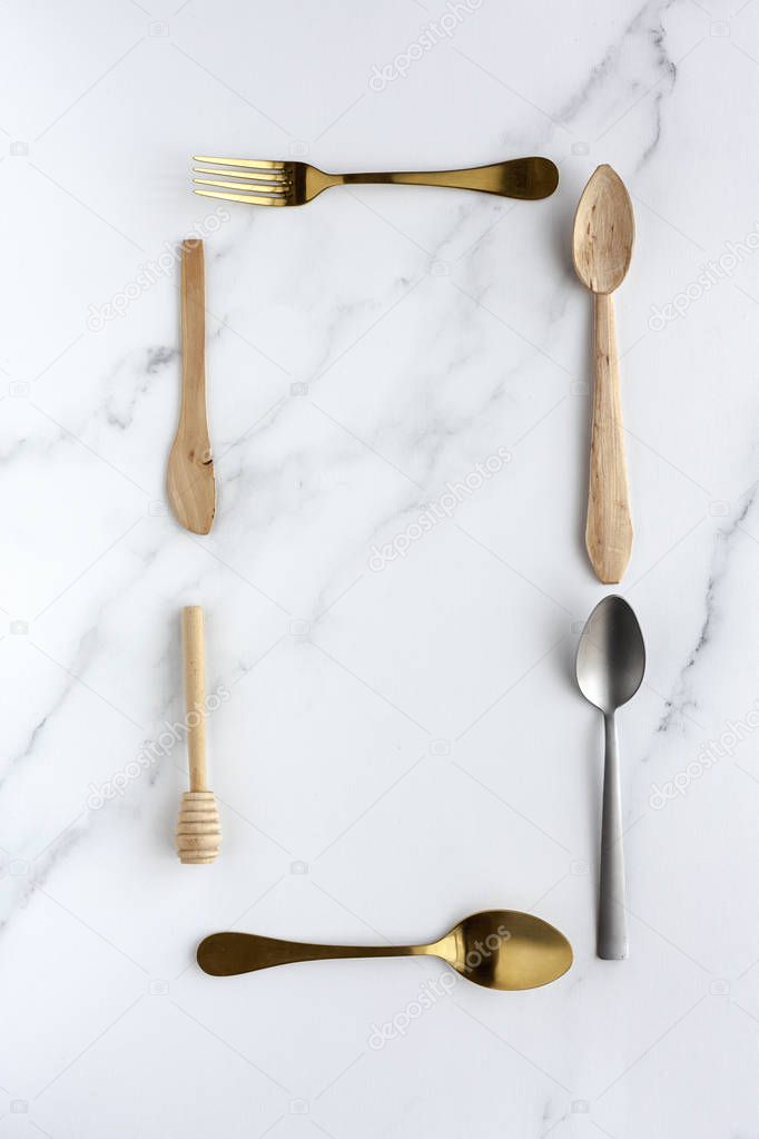 Spoons and forks on white background