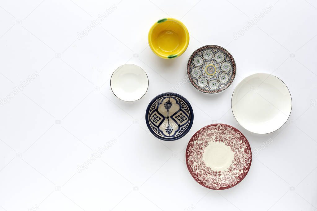 Crockery and forks on white background