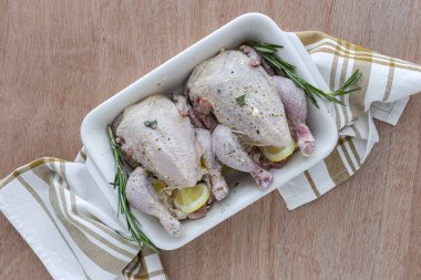 Çiğ koquelet tavukları sebze ve aromatik otlarla kızartılmaya hazır. limon, pırasa ve havuç.