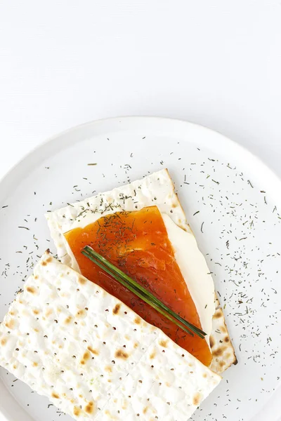 Salty crackers with salmon and cheese from above on colors background. Flat lay. Top view
