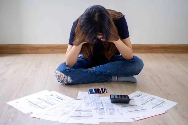Asian woman are stressed about financial problems With invoices and various bills. problems with home expenses. debt concept