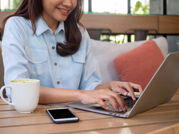 Asian women or emotional writers are typing computers to advertise products. Search for information or work through laptops at home or coffee shop. Ecommerce Internet Concepts