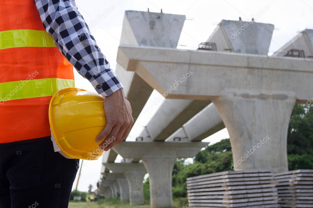 The inspectors or engineers are checking the work of the contractor team to build a bridge over the road.