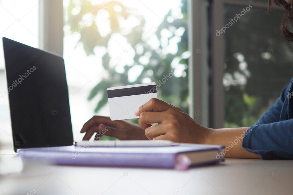 Young women holding credit cards, spending money online. Order online