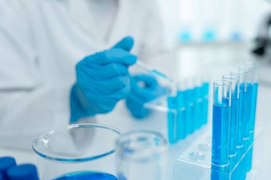 Scientist analyze biochemical samples in advanced scientific laboratory. Medical professional use dropper mix microbiological developmental of viral. Biotechnology research in  science lab. cosmetic