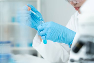 Scientist analyze biochemical samples in advanced scientific laboratory. Medical professional use dropper mix microbiological developmental of viral. Biotechnology research in  science lab. cosmetic